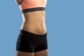 Fit woman wearing shorts and sport top showing slim beautiful stomach and abs Royalty Free Stock Photo