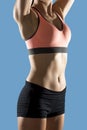 Fit woman wearing shorts and sport top showing slim beautiful stomach and abs Royalty Free Stock Photo