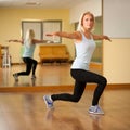 Fit woman work out in gym making lunge step Royalty Free Stock Photo