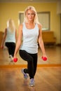 Fit woman work out in gym making lunge step Royalty Free Stock Photo