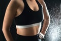 Fit woman in workout clothes. Weightlifting, gym training and fitness concept. Confident lady in sportswear and sports bra.