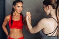 Fit women holding hands with a female opponent looking in her eyes. Royalty Free Stock Photo