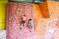 Fit women rock climbing indoors Royalty Free Stock Photo