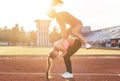 Fit women at the stadium playing leap frog. Royalty Free Stock Photo