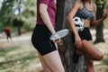 Fit women taking a break in a park after a cardio training session. They hold sport equipment, discuss fitness goals and Royalty Free Stock Photo