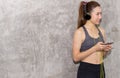 Fit women using headphone and listening to music while relax after the training session in gym,Concept healthy and lifestyle,Femal Royalty Free Stock Photo