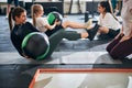 Fit women working on their abs and using fitness balls Royalty Free Stock Photo