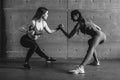 Fit woman wrestle on hands with a female opponent looking in her eyes. Royalty Free Stock Photo