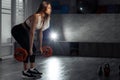 Fit young blonde woman doing heavy barbell exercise for back in fitness class. Royalty Free Stock Photo