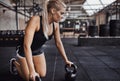 Fit young woman working out with weights in a gym Royalty Free Stock Photo