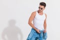 Fit young casual man with sunglasses looks down to side Royalty Free Stock Photo