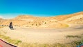 Fit young caucasian male person cycle with touring bicycle uphill in deserted road in caucasus mountains. Achievement ,