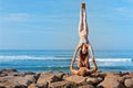 Fit young couple doing acro yoga exercise at sea beach Royalty Free Stock Photo