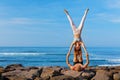 Fit young couple doing acro yoga exercise at sea beach Royalty Free Stock Photo