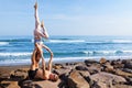 Fit young couple doing acro yoga exercise at sea beach Royalty Free Stock Photo