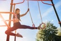 Fit young female doing pull ups exercises on crossbar outdoors. Sport and healthy lifestyle concept Royalty Free Stock Photo