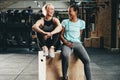 Fit young female friends laughing together after a gym workout Royalty Free Stock Photo