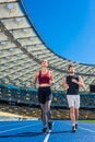 fit young male and female joggers running on track Royalty Free Stock Photo