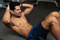 Latin man strengthening his core muscles Royalty Free Stock Photo