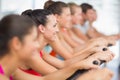 Fit young people working out at spinning class Royalty Free Stock Photo