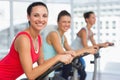 Fit young people working out at spinning class Royalty Free Stock Photo