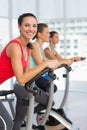 Fit young people working out at spinning class Royalty Free Stock Photo