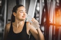 Fit young woman caucasian sitting and resting after workout or exercise in fitness gym. woman at gym taking a break and relax Royalty Free Stock Photo