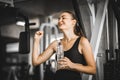 Fit young woman caucasian sitting and resting after workout or exercise in fitness gym. woman at gym taking a break and relax Royalty Free Stock Photo