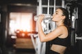 Fit young woman caucasian sitting and resting after workout or exercise in fitness gym. woman at gym taking a break and relax Royalty Free Stock Photo