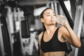 Fit young woman caucasian sitting and resting after workout or exercise in fitness gym. woman at gym Royalty Free Stock Photo