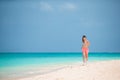 Fit young woman doing exercises on tropical white beach in her sportswear Royalty Free Stock Photo