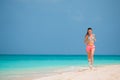 Fit young woman doing exercises on tropical white beach in her sportswear Royalty Free Stock Photo