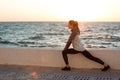 Fit young woman doing stretching workout at the seaside Royalty Free Stock Photo