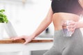 Fit young woman with glass of water in modern kitchen Royalty Free Stock Photo