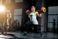 Fit young woman lifting barbells looking focused, working out in a gym Royalty Free Stock Photo