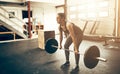 Fit young woman lifting weights during a gym workout Royalty Free Stock Photo