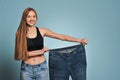 Fit young woman in loose jeans Royalty Free Stock Photo
