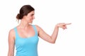 Fit young woman pointing to her left Royalty Free Stock Photo