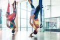 Fit young woman practicing aerial yoga in a modern fitness club