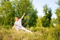 Fit young woman practicing yoga on park outside the city. Meditative lady enjoying meditation Royalty Free Stock Photo