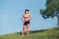 Fit young woman resting after training in park