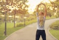 Fit young woman running in park - Attractive blonde female doing stretching exercises outdoors - healthy lifestyle concept