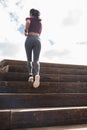 Fit young woman running up stairs Royalty Free Stock Photo