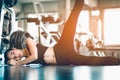 Fit young woman sitting and resting after workout or exercise in fitness gym. woman at gym taking a break and relax Royalty Free Stock Photo