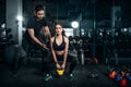 Fit young woman in sportswear focused on lifting a dumbbell during an exercise class in a gym Royalty Free Stock Photo