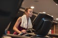 Woman training in fitness center, running on treadmill Royalty Free Stock Photo