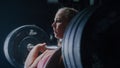 A Fit Young Woman Tries Training with Extreme Weights and Succeeds. Portrait of a Focused Female