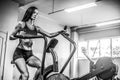 Fitness female using air bike for cardio workout at crossfit gym. Royalty Free Stock Photo