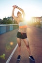 Fit young woman warming up before a workout