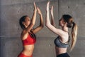 Fit young woman giving high five to friend after workout